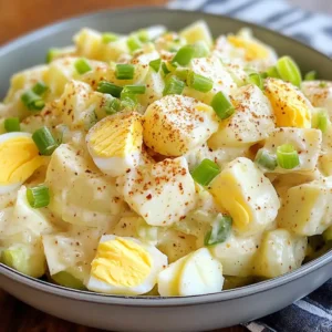 A bowl of creamy American Potato Salad with tender potatoes, crisp celery, and a rich mayonnaise dressing, garnished with fresh parsley.